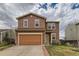 Two-story home boasts a two-car garage and a well-maintained front yard at 303 Diablo Pl, Brighton, CO 80603