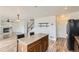 Modern eat-in kitchen with a central island featuring barstool seating at 303 Diablo Pl, Brighton, CO 80603