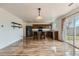 Open kitchen and dining area with modern wood cabinets, stainless appliances, and glass sliding door to backyard at 303 Diablo Pl, Brighton, CO 80603