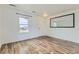 Inviting living room features wood floors, ample natural light and a large mirror at 303 Diablo Pl, Brighton, CO 80603