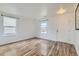Bright living room with wood floors, ample natural light, and a modern design at 303 Diablo Pl, Brighton, CO 80603