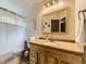 Bathroom with a white shower curtain, wood vanity and nautical themed decor at 11523 Sandy Creek Ln, Parker, CO 80138