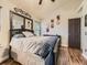 Bedroom featuring hardwood floors, a ceiling fan and mirrored decor at 11523 Sandy Creek Ln, Parker, CO 80138