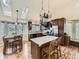 Bright kitchen with skylight, dining table and island, featuring stainless steel appliances and wood cabinets at 11523 Sandy Creek Ln, Parker, CO 80138