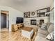 Living room with a fireplace, hardwood floors, shelving and a flat screen TV at 11523 Sandy Creek Ln, Parker, CO 80138