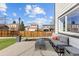 Well-designed back patio featuring a cozy lounge area and a modern fire pit, perfect for outdoor gatherings at 16402 E Tennessee Ave, Aurora, CO 80017