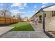 Backyard featuring an artificial turf, patio, and a wooden fence perfect for outdoor enjoyment and relaxation at 16402 E Tennessee Ave, Aurora, CO 80017