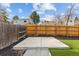 Backyard featuring an artificial grass and concrete slab, enclosed by a wooden fence for added privacy at 16402 E Tennessee Ave, Aurora, CO 80017