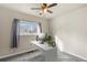 Bedroom boasts a ceiling fan, plush carpet, and a modern desk setup near a sunny window at 16402 E Tennessee Ave, Aurora, CO 80017