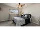 Comfortable bedroom featuring a ceiling fan, a cozy bed, and a large window bringing in natural light at 16402 E Tennessee Ave, Aurora, CO 80017