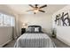 Inviting bedroom featuring a ceiling fan, a cozy bed, and a large window bringing in natural light at 16402 E Tennessee Ave, Aurora, CO 80017