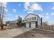 Beautiful two-story home featuring painted brick and siding, an attached garage, and a landscaped front yard at 16402 E Tennessee Ave, Aurora, CO 80017