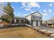 Well-maintained two-story home with a front yard featuring xeriscaping and a two-car garage at 16402 E Tennessee Ave, Aurora, CO 80017