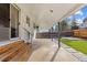 Covered patio featuring wood stairs, concrete flooring, metal support beams and view of a small artificial grass area at 16402 E Tennessee Ave, Aurora, CO 80017