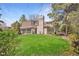 Large backyard with expansive lawn and mature landscaping provides a private outdoor space at 5442 S Dayton Ct, Greenwood Village, CO 80111