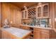 Stylish wet bar with custom cabinetry, wine rack, and unique design features for entertaining guests at 5442 S Dayton Ct, Greenwood Village, CO 80111