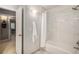 Bathroom featuring a white tile shower and a doorway leading to another room at 5442 S Dayton Ct, Greenwood Village, CO 80111