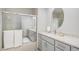 Bathroom with a gray double vanity, white countertop, and glass door shower at 5442 S Dayton Ct, Greenwood Village, CO 80111