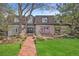 Charming two-story home with beautiful landscaping and a brick walkway leading to the front door at 5442 S Dayton Ct, Greenwood Village, CO 80111