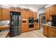 Modern kitchen with stainless steel appliances, wood cabinetry, and stylish backsplash for a contemporary feel at 5442 S Dayton Ct, Greenwood Village, CO 80111