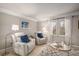 Cozy living room with two comfortable armchairs, stylish lamps, and a modern glass coffee table at 5442 S Dayton Ct, Greenwood Village, CO 80111