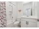 Charming bathroom with a tub-shower combo, white vanity, and butterfly-themed decor at 12314 Hayloft Ln, Thornton, CO 80241