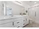 Elegant bathroom featuring a double sink vanity, framed mirror, and glass-enclosed shower at 12314 Hayloft Ln, Thornton, CO 80241