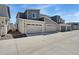 Townhome featuring a two-car garage and neutral gray exterior at 12314 Hayloft Ln, Thornton, CO 80241