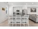 Contemporary kitchen featuring stainless steel appliances, white cabinets, and a spacious island with barstools at 12314 Hayloft Ln, Thornton, CO 80241