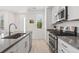 Modern kitchen features stainless steel appliances, gray countertops, and a spacious island with a sink at 12314 Hayloft Ln, Thornton, CO 80241
