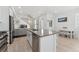 Open floor plan seamlessly integrates the kitchen, dining area, and living room, creating an airy and inviting space at 12314 Hayloft Ln, Thornton, CO 80241