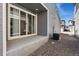 Back patio features sliding glass doors and low maintenance landscaping at 12314 Hayloft Ln, Thornton, CO 80241