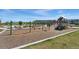 Community playground featuring a swing set, playground equipment, and picnic tables at 12314 Hayloft Ln, Thornton, CO 80241