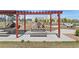 Community playground featuring covered seating, playground equipment, and open space at 12314 Hayloft Ln, Thornton, CO 80241