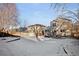 Spacious backyard with patio and playset, partially covered by snow at 9573 Castle Ridge Cir, Highlands Ranch, CO 80129