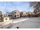 Spacious backyard with patio, partially covered by snow at 9573 Castle Ridge Cir, Highlands Ranch, CO 80129