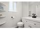 Updated bathroom with white vanity, black fixtures, and shelving at 9573 Castle Ridge Cir, Highlands Ranch, CO 80129