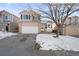 Two-story house with attached garage and snow-covered front yard at 9573 Castle Ridge Cir, Highlands Ranch, CO 80129