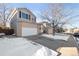 Two-story house with attached garage and snow-covered driveway at 9573 Castle Ridge Cir, Highlands Ranch, CO 80129