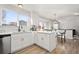 Bright kitchen with island, white cabinets, and hardwood floors at 9573 Castle Ridge Cir, Highlands Ranch, CO 80129