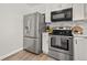 Stainless steel appliances and white shaker cabinets in this kitchen at 9573 Castle Ridge Cir, Highlands Ranch, CO 80129