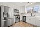 Modern kitchen features white cabinets, stainless steel appliances, and marble countertops at 9573 Castle Ridge Cir, Highlands Ranch, CO 80129