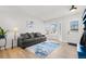 Living room with bay window and gray couch at 9573 Castle Ridge Cir, Highlands Ranch, CO 80129