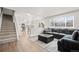 Open concept living room with stairs and view of kitchen at 9573 Castle Ridge Cir, Highlands Ranch, CO 80129