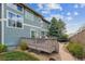 Backyard deck with outdoor seating perfect for entertaining, a stone walkway, and lush landscaping at 8406 Winter Berry Dr, Castle Pines, CO 80108