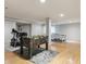 Finished basement with hardwood floors, foosball and ping pong tables, and workout area at 8406 Winter Berry Dr, Castle Pines, CO 80108