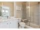 Clean bathroom with double sinks, and a glass-enclosed shower and a small medicine cabinet at 8406 Winter Berry Dr, Castle Pines, CO 80108