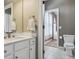 Bathroom showcasing white vanity with marble countertop, modern fixtures, and an adjacent water closet at 8406 Winter Berry Dr, Castle Pines, CO 80108