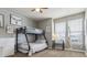 Comfortable bedroom with bunkbeds, two windows for natural light, and cozy gray walls at 8406 Winter Berry Dr, Castle Pines, CO 80108
