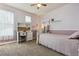 Cozy bedroom featuring soft lavender walls, carpet flooring, and a built in desk with shelving at 8406 Winter Berry Dr, Castle Pines, CO 80108